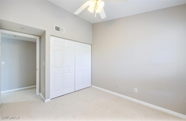 4625 Saint Croix Ln Unit 1132, Naples, FL 34109 - unfurnished bedroom with light colored carpet, a closet, and a ceiling fan