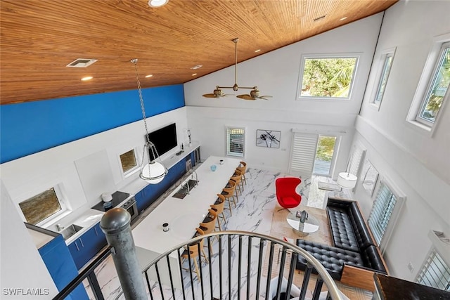 living room featuring ceiling fan, high vaulted ceiling, plenty of natural light, and wood ceiling