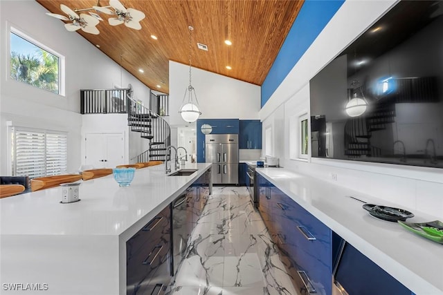 kitchen featuring pendant lighting, high vaulted ceiling, a large island with sink, sink, and wood ceiling