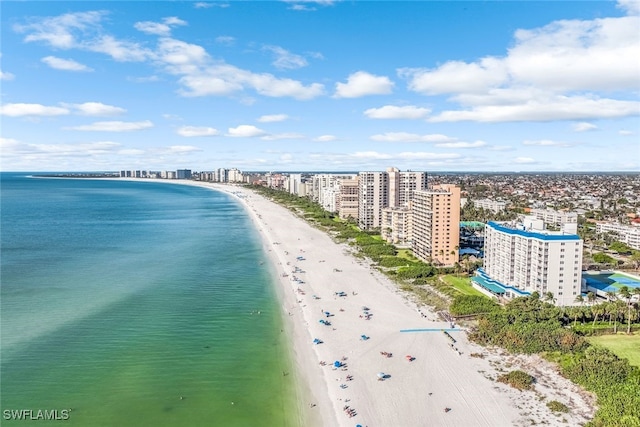 birds eye view of property with a water view and a beach view