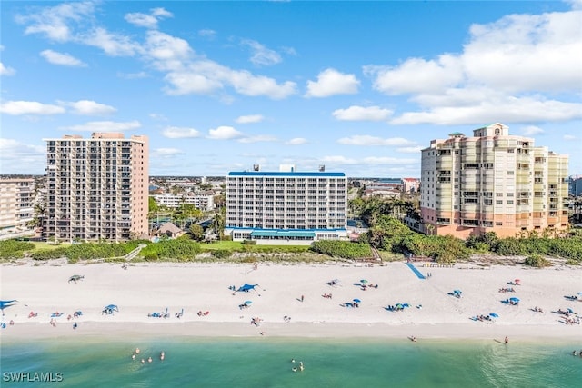 drone / aerial view with a beach view and a water view