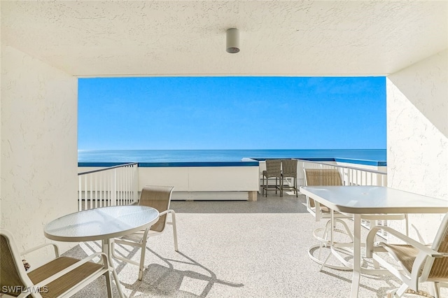 balcony with a view of the beach and a water view