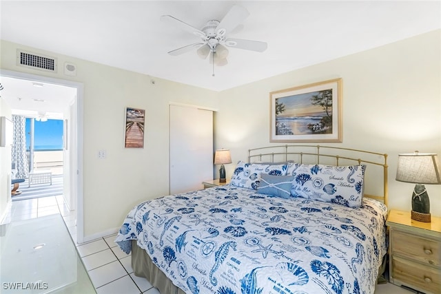 tiled bedroom with ceiling fan