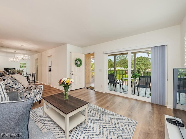 living room with a chandelier and hardwood / wood-style flooring