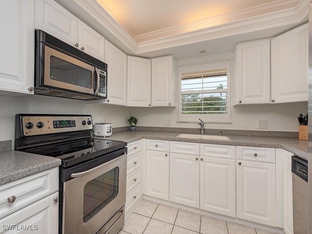 kitchen featuring white cabinetry, appliances with stainless steel finishes, ornamental molding, and sink