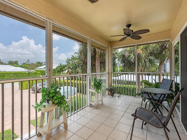 sunroom / solarium featuring ceiling fan