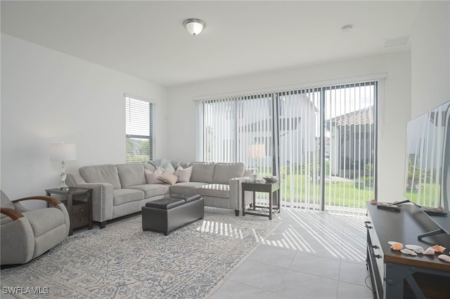 living room with light tile patterned floors and plenty of natural light