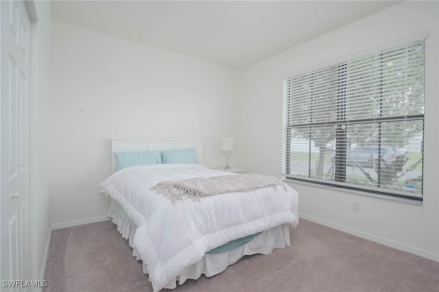 bedroom featuring light colored carpet