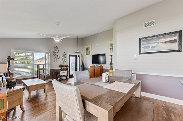 dining space featuring hardwood / wood-style floors, french doors, and lofted ceiling