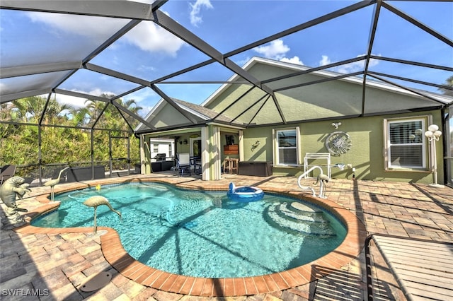 view of swimming pool with a patio area and a lanai