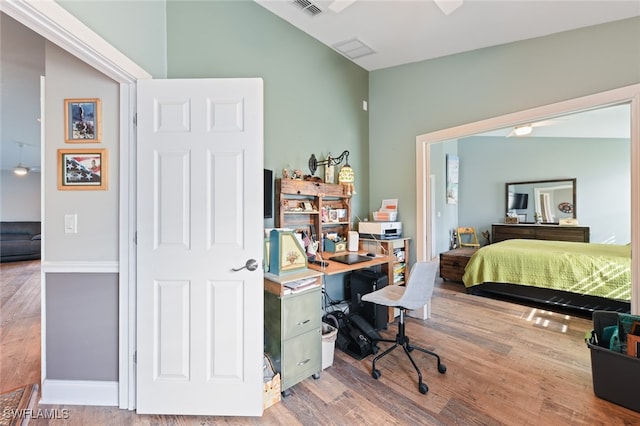 office space featuring lofted ceiling and hardwood / wood-style floors