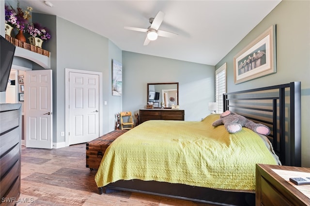 bedroom featuring lofted ceiling, hardwood / wood-style flooring, and ceiling fan