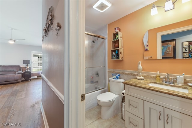 full bathroom featuring toilet, vanity, bath / shower combo with glass door, and wood-type flooring