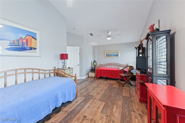 bedroom featuring dark hardwood / wood-style flooring, lofted ceiling, and ceiling fan