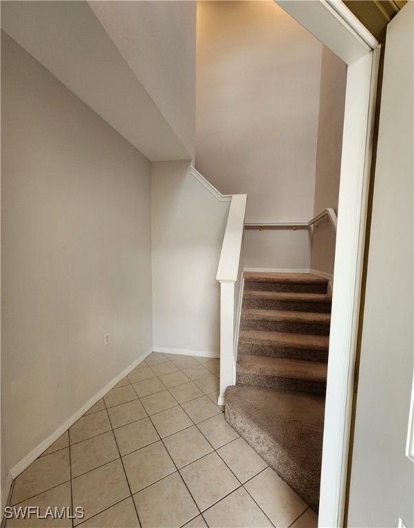 stairs with tile patterned flooring