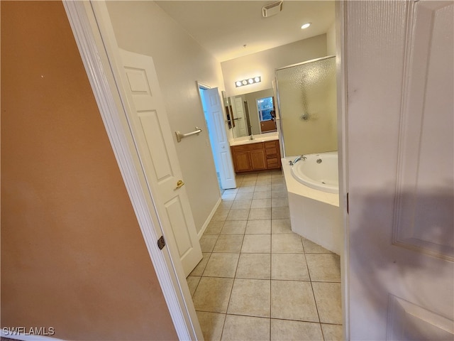 bathroom featuring vanity, plus walk in shower, and tile patterned flooring