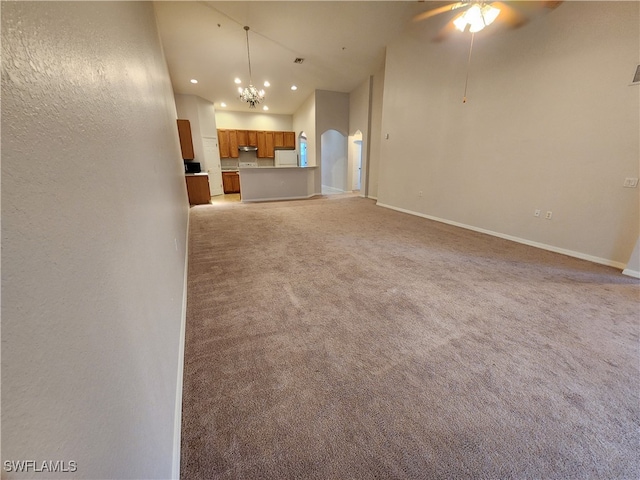 unfurnished living room with light colored carpet and ceiling fan with notable chandelier