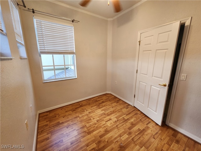 unfurnished room with light wood-type flooring, ceiling fan, and ornamental molding