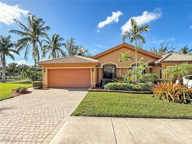 mediterranean / spanish-style house with a front yard and a garage