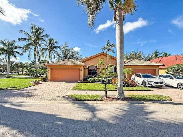 view of front facade featuring a front yard and a garage