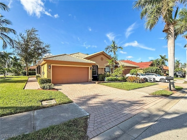 view of front of property featuring a front yard and a garage