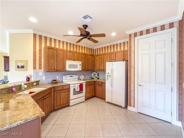 kitchen featuring kitchen peninsula, light stone counters, ornamental molding, white appliances, and ceiling fan