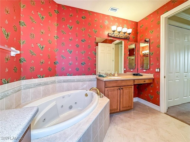 bathroom featuring tiled tub and vanity