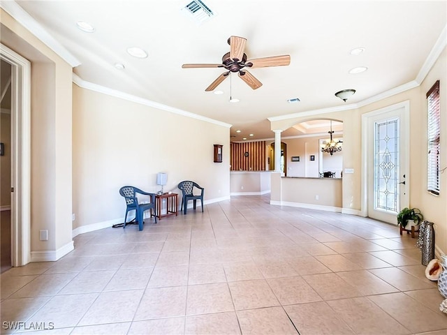 living room featuring light tile patterned floors, ceiling fan with notable chandelier, decorative columns, and ornamental molding