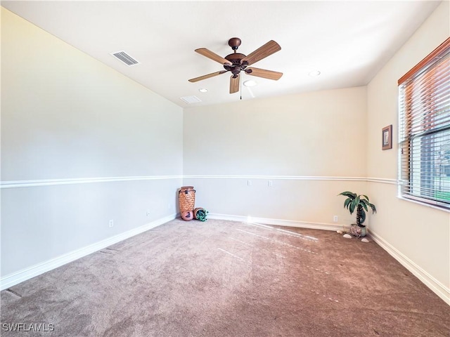 spare room featuring carpet flooring and ceiling fan