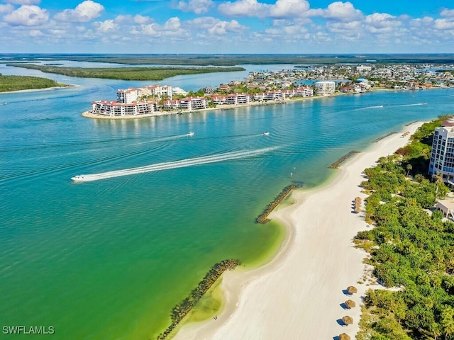 birds eye view of property with a beach view and a water view