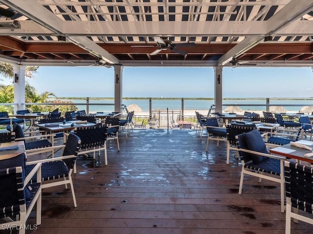 wooden terrace featuring a water view and ceiling fan