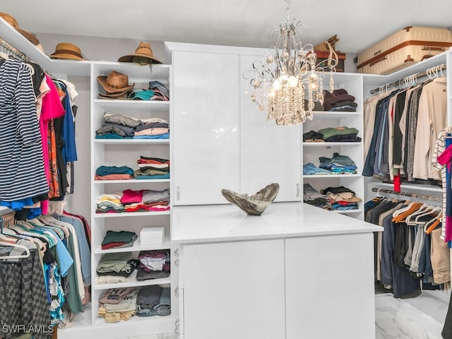 walk in closet with a chandelier