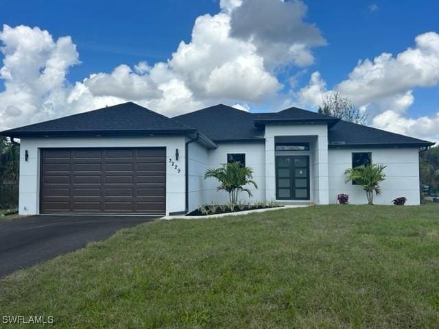 view of front of home featuring a garage and a front yard