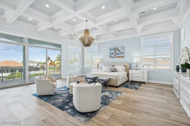 bedroom featuring beam ceiling, multiple windows, a chandelier, and access to exterior