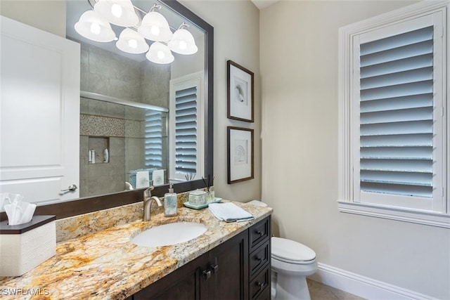 bathroom with tile patterned flooring, a chandelier, toilet, vanity, and an enclosed shower