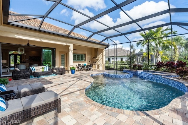 view of swimming pool with a lanai, a patio, outdoor lounge area, ceiling fan, and an in ground hot tub