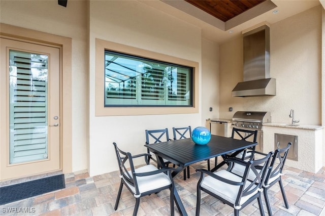 dining room with sink and a raised ceiling