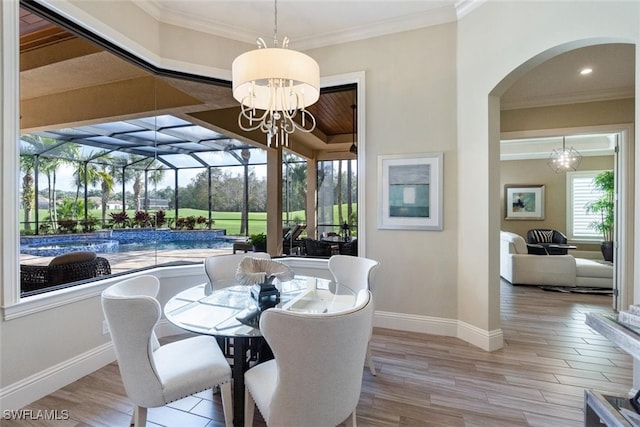 dining space featuring ornamental molding and light hardwood / wood-style floors