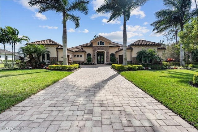 mediterranean / spanish-style home featuring a front yard