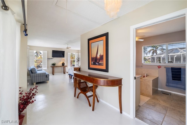 hall featuring concrete floors and a textured ceiling