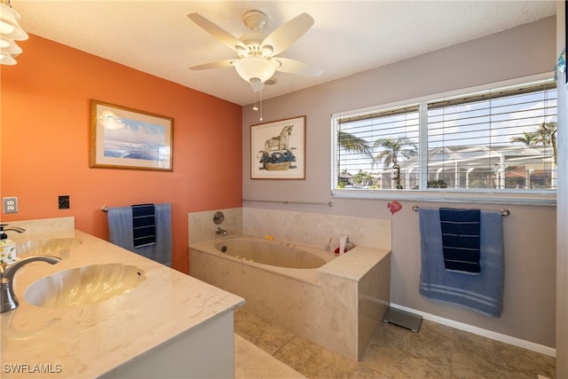 bathroom with vanity, a textured ceiling, tile patterned flooring, a tub to relax in, and ceiling fan