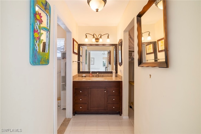 corridor featuring sink and light tile patterned flooring