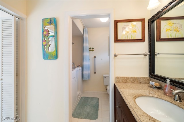 bathroom with vanity, tile patterned flooring, and toilet