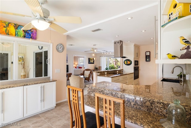 dining area with sink, ceiling fan, and light tile patterned flooring