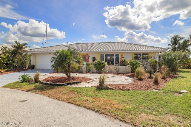 single story home with a garage and a front yard