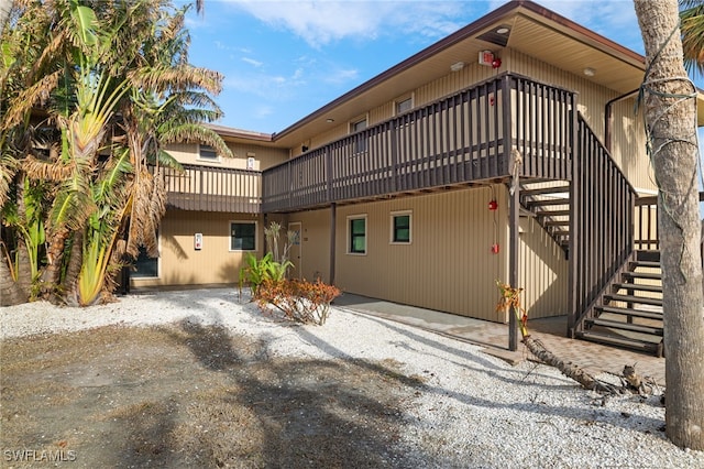 view of side of property with a patio and a deck