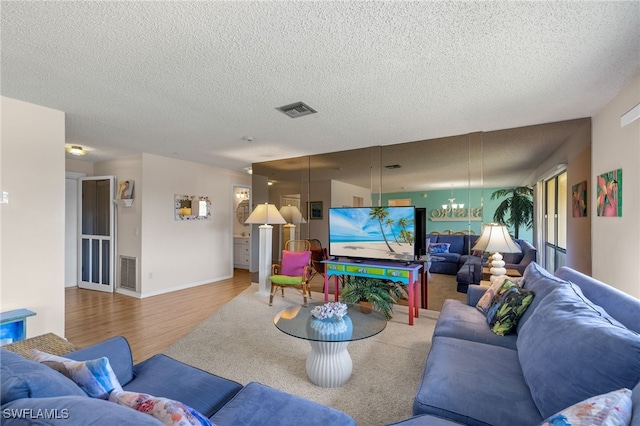 living room with wood-type flooring and a textured ceiling