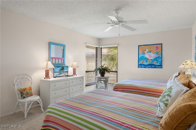 bedroom with a textured ceiling, light carpet, and ceiling fan