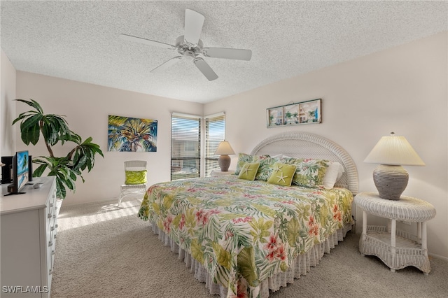 carpeted bedroom with a textured ceiling and ceiling fan