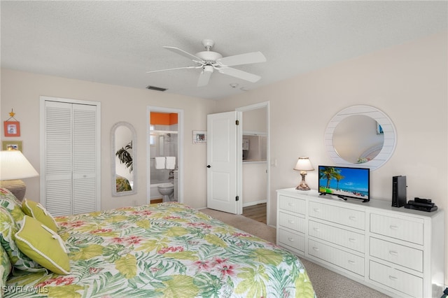 bedroom with ceiling fan, a textured ceiling, connected bathroom, a closet, and carpet floors